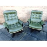 GEORG THAMS: A PAIR OF SWIVEL ARMCHAIRS with green leather button upholstery