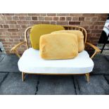 A LIGHT ERCOL TWO-SEATER STICK-BACK SOFA 131cm wide 67cm deep 80cm high