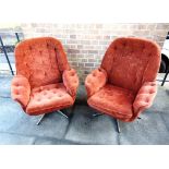 A PAIR OF ORANGE VELOUR SWIVEL ARMCHAIRS on five prong chrome bases