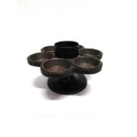 A CAST IRON 'LAZY SUSAN' with six removable tin trays, 32cm diameter 19cm high