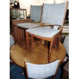 A TEAK DINING ROOM SUITE comprising extending circular table on quatrefoil support, 125cm diameter