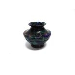 A COLOURED GLASS VASE in mottled blue, green and purple colourway, ground pontil to base, 17.5cm