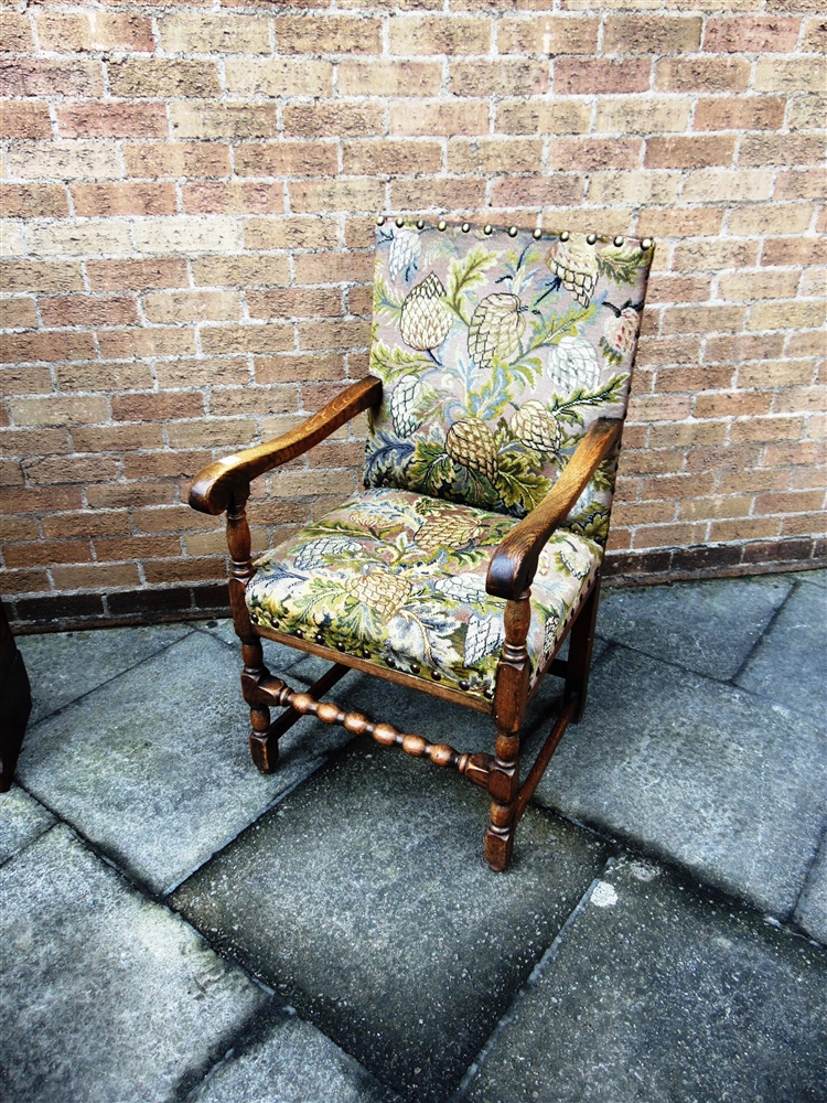 A LARGE OAK FRAMED ARMCHAIR with tapestry upholstery, 58cm wide 64cm deep 106cm high