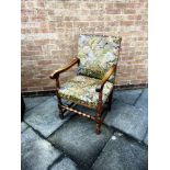 A LARGE OAK FRAMED ARMCHAIR with tapestry upholstery, 58cm wide 64cm deep 106cm high