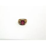 A SYNTHETIC RUBY SET RING with Egyptian marks to the outside of the shank, 6.6g gross