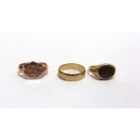 A 9 CARAT GOLD SIGNET RING monogrammed; a 9 carat gold tiger eye ring; and a 9 carat gold wedding