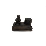 [TREEN] A BLACK FOREST DESK STAND with seated bear beside a tree trunk opening to inkwell, 13cm