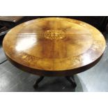 A CIRCULAR DINING TABLE WITH MARQUETRY DECORATION on carved quatrefoil base, extending but lacking