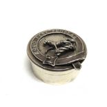 A SILVER CIRCULAR BOX maker C.E.T., Birmingham 1915, with applied modelled crest of a horse passant,