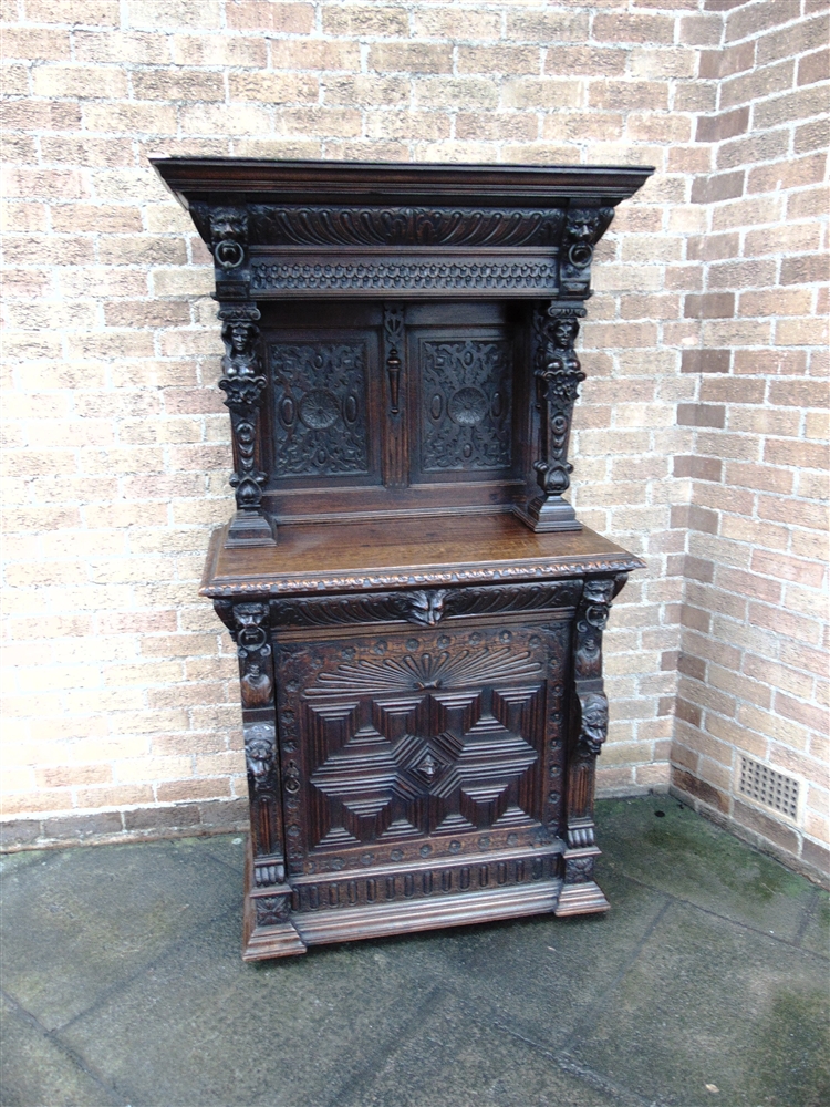 A VICTORIAN CARVED OAK SIDE CABINET the upper section with moulded frieze above female caryatid