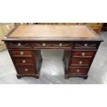 AN EDWARDIAN MAHOGANY TWIN PEDESTAL DECK with swag decoration to the three frieze drawers, 125cm