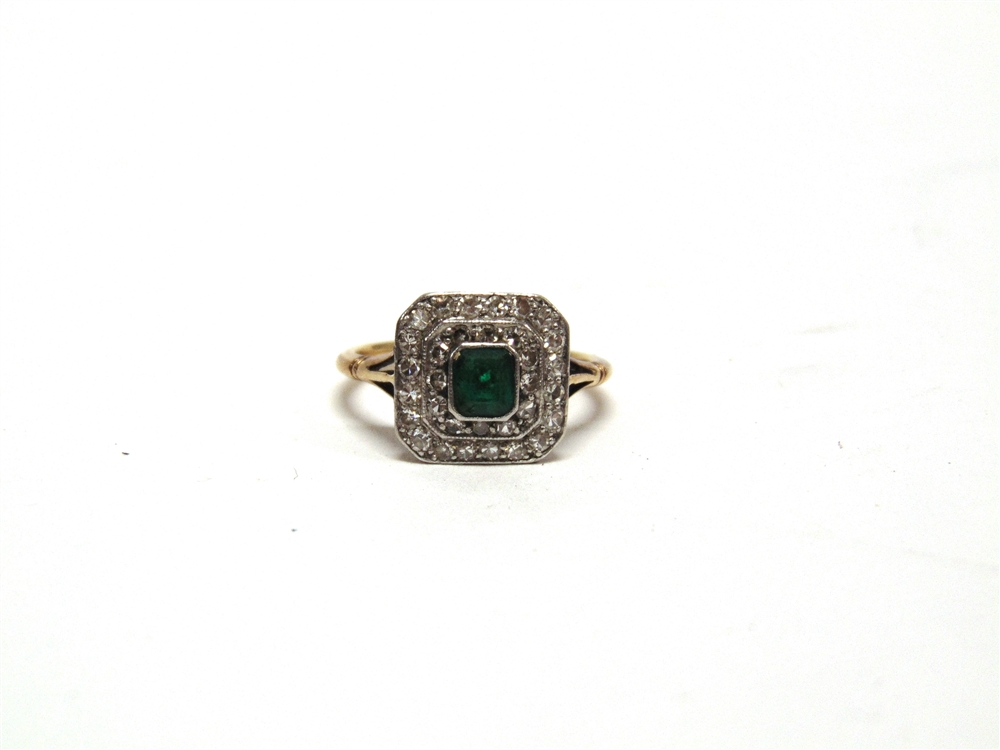 AN EMERALD AND DIAMOND CLUSTER PANEL RING stamped '18ct & Pt', the step cut measuring