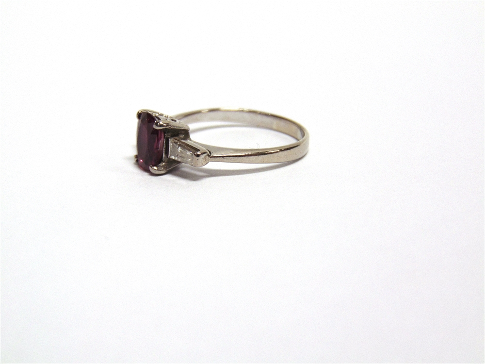 A RUBY AND DIAMOND THREE STONE RING unmarked, the oval cut stone approximately 7.6mm by 6.7mm by 3. - Image 2 of 4