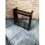AN ARTS & CRAFTS STYLE OAK STICK STAND with pierced decoration to the ends and inset metal drip