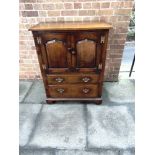 AN OAK REPRODUCTION SIDE CABINET in the manner of Tithchmarsh & Goodwin, fitted with pair of doors