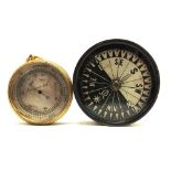 A POCKET BAROMETER with a circular silvered dial and a gilt metal body, 5.5cm diameter, in a leather