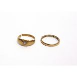A 22 CARAT GOLD WEDDING RING 2.6g gross; with an 18 carat gold ring, cut shank, set with a