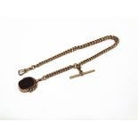 A 9 CARAT GOLD WATCH CHAIN of solid graduated curb links, 32cm long, with T bar and swivel, also a