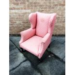 A RE-UPHOLSTERED WING ARMCHAIR with scroll arms, on cabriole supports, 74cm wide 77cm deep 102cm