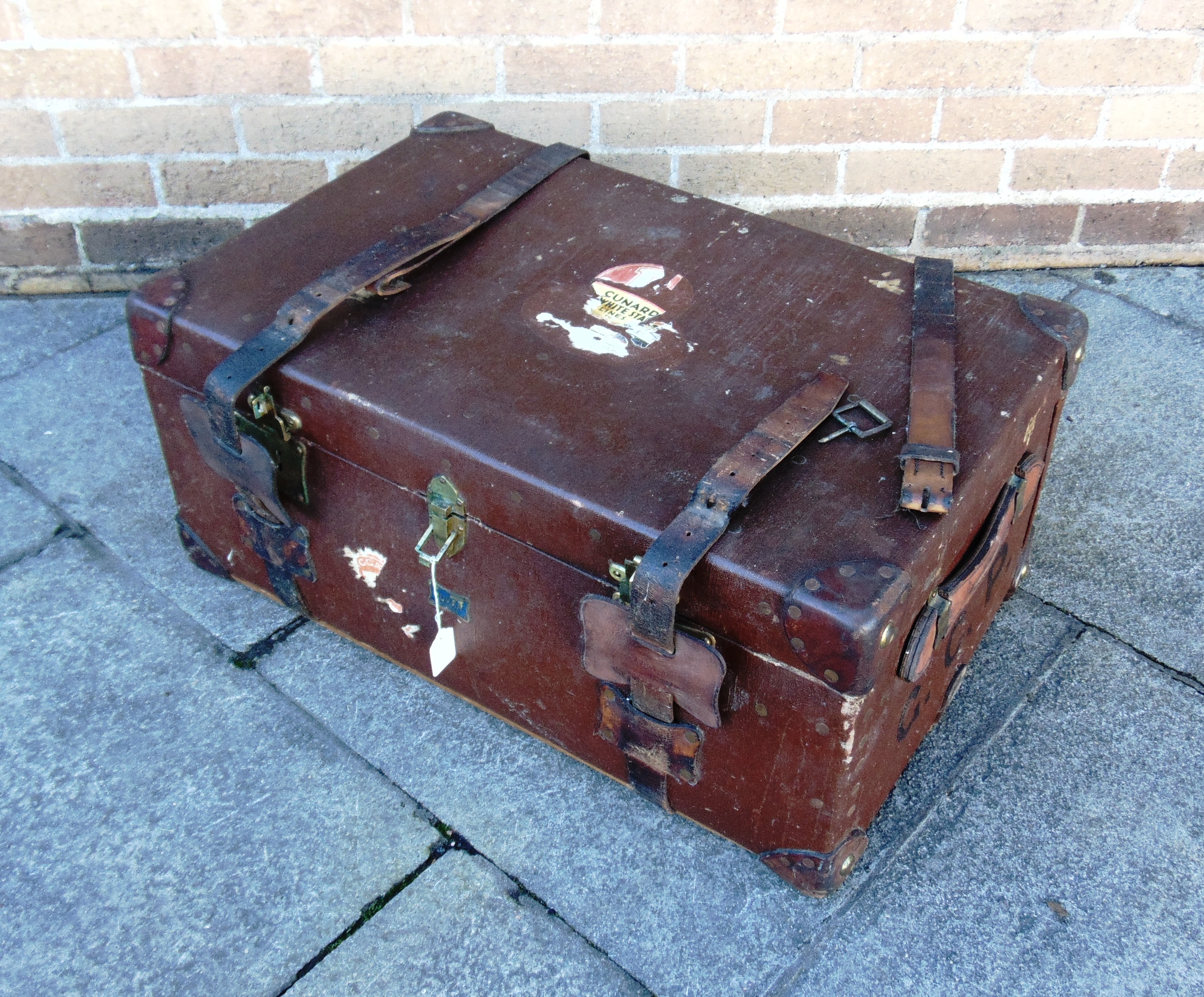 A LEATHER BOUND CANVAS TRUNK by Pukka Luggage, with fitted interior and ivorine 'Harrods' label,