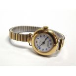 PEERTONE, A LADY'S 18 CARAT GOLD WRISTWATCH on a later expending bracelet.