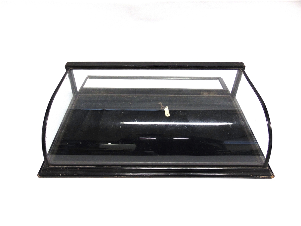 A VICTORIAN EBONISED TABLE TOP DISPLAY CABINET with curved glass top, removable velvet lined tray