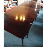 A 19TH CENTURY MAHOGANY EXTENDING DINING TABLE on ring turned supports, with central drop leaf