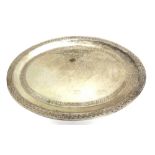 A METALWARE TRAY probably Indian, of oval outline, embossed borders, 45cm long, 639g (20.6 troy ozs)