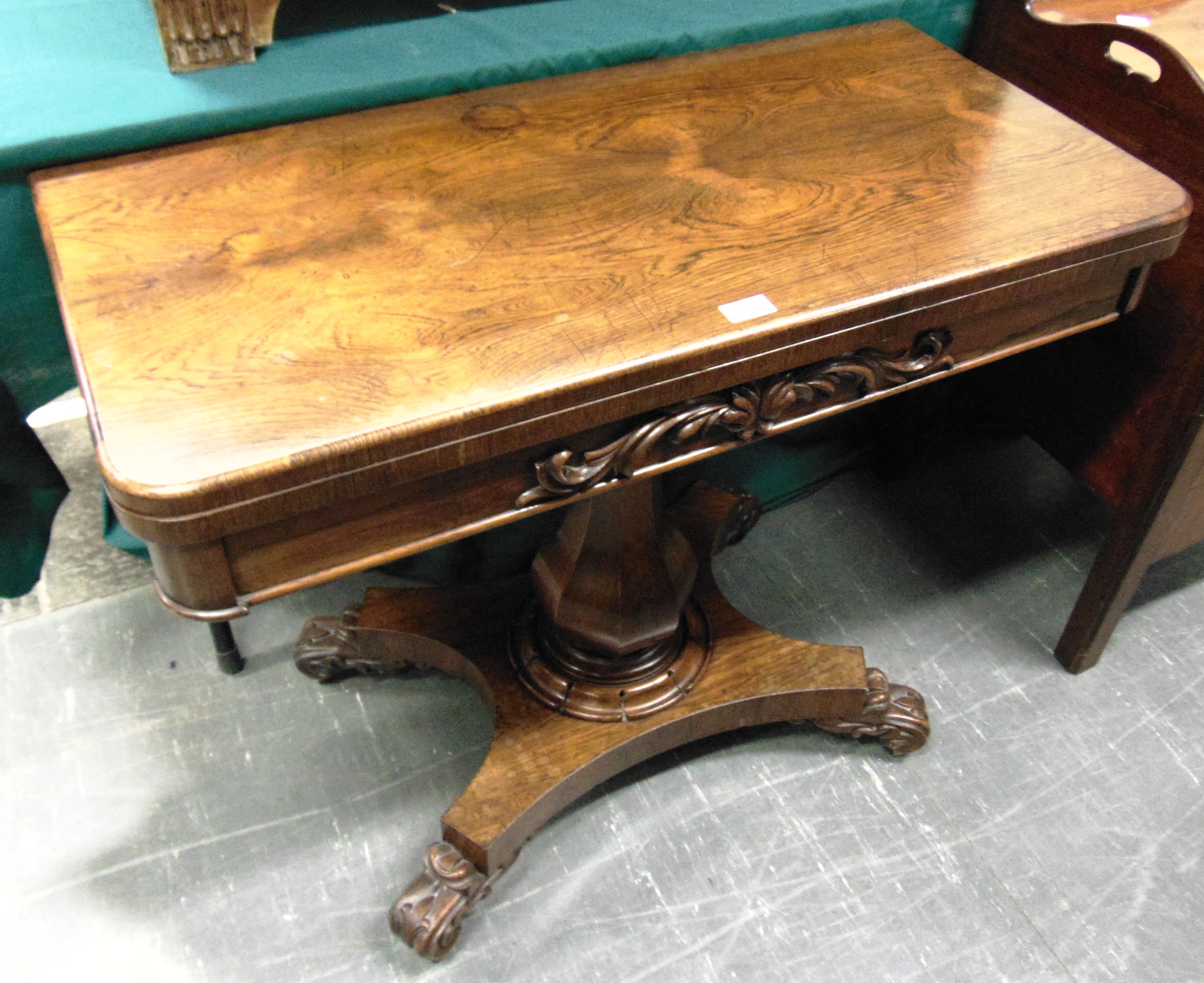 A WILLIAM IV ROSEWOOD CARD TABLE the frieze with carved decoration, on octagonal inverted baluster