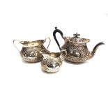 A LATE VICTORIAN SILVER THREE PIECE TEA SERVICE by Mappin Brothers, Lon 1893, of oval outline,