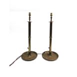 A PAIR OF LARGE BRASS EJECTOR CANDLESTICKS converted to electricitry, 41cm high (excluding