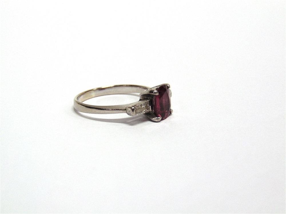 A RUBY AND DIAMOND THREE STONE RING unmarked, the oval cut stone approximately 7.6mm by 6.7mm by 3. - Image 3 of 4