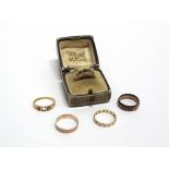 A 9 CARAT GOLD ETERNITY RING a 9 carat gold wedding ring; another, a fire stone green doublet 9