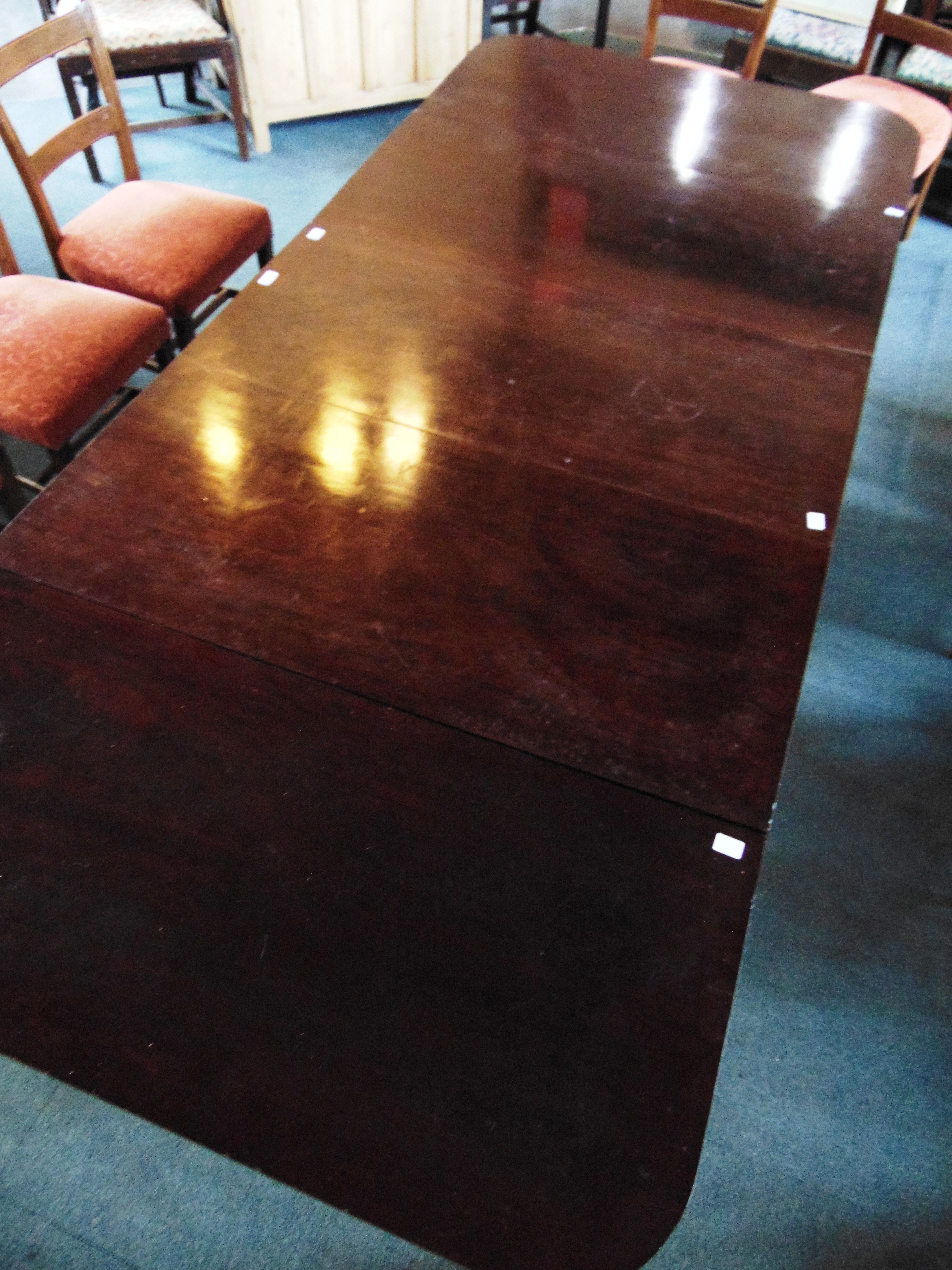 A 19TH CENTURY MAHOGANY EXTENDING DINING TABLE on ring turned supports, with central drop leaf - Image 2 of 2