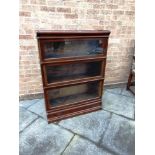 A THREE TIER MAHOGANY GLOBE WERNICKE SECTIONAL BOOKCASE fitted with drawer to base section, 86cm