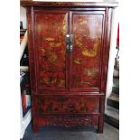 A CHINESE LACQUERED CABINET gilt decorated with figures in landscape settings on a red ground,
