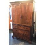 A MAHOGANY LINEN PRESS the upper section with moulded frieze above doors enclosing hanging space,