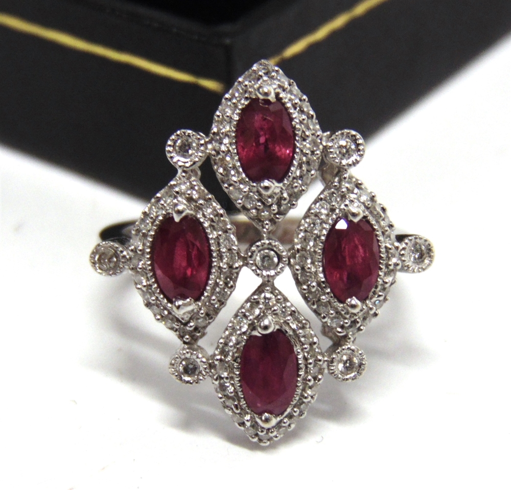 AN 18CT WHITE GOLD DRESS RING set with four oval rubies approximately 1.34ct in total and round