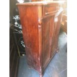 A 19TH CENTURY CONTINENTAL FIGURED MAHOGANY CABINET with shaped drawer above pair of panelled doors,