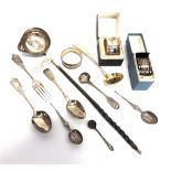 A SMALL COLLECTION OF SILVER FLATWARE including a coin set toddy ladle; and three silver napkin