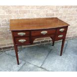 AN EDWARDIAN MAHOGANY BOW FRONT DRESSING TABLE fitted with four drawers to frieze, on square