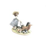 A LLADRO FIGURAL GROUP 'PUPPY PARADE' no. 6784, modelled as a young girl walking a group of dogs,