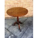 AN OAK TRIPOD OCCASIONAL TABLE the circular top 61cm diameter, 72cm high overall