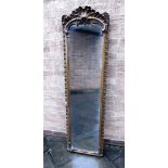 A LARGE GILT FRAMED WALL MIRROR in rococo moulded gesso frame, 51cm wide 180cm high