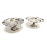 A MATCHED PAIR OF SILVER COMPORTS by F.C. Richards, Birmingham 1923 and 1924, the shaped circular