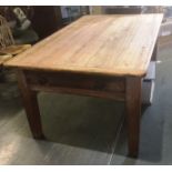 A PITCH PINE KITCHEN TABLE with frieze drawer to each end, on square tapering supports, 107cm wide