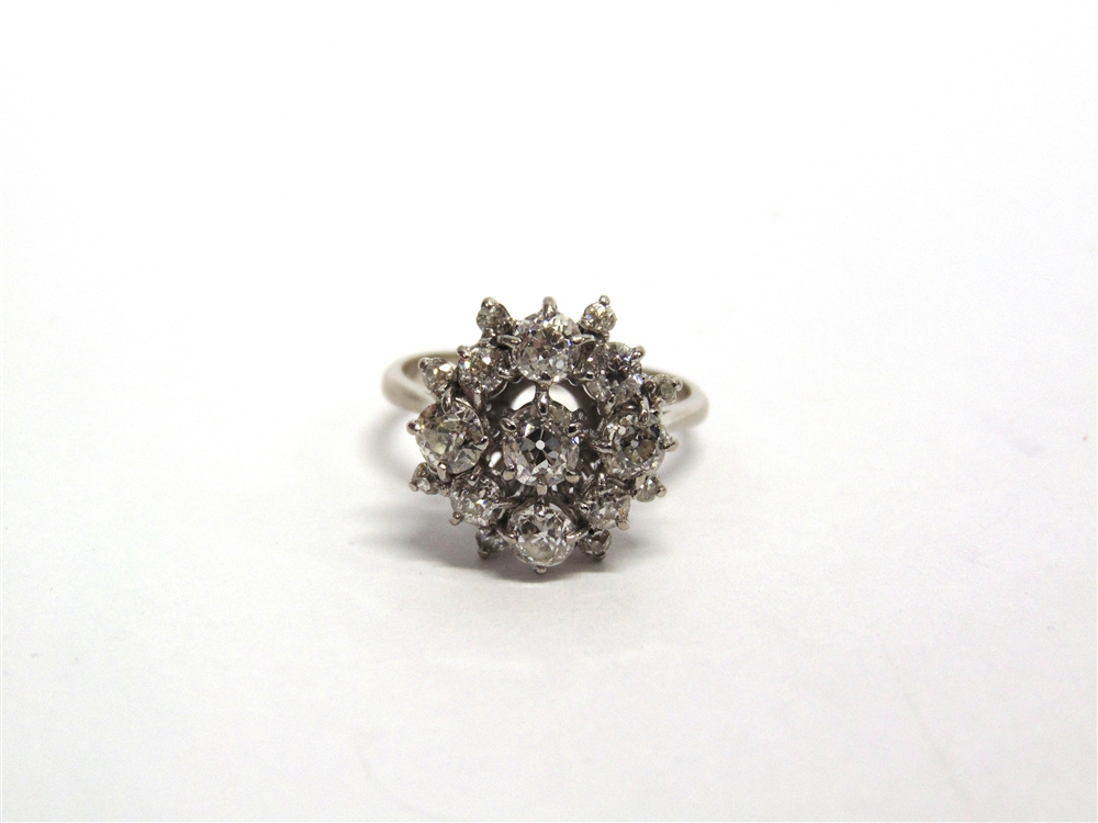 A SEVENTEEN STONE DIAMOND CLUSTER RING the yellow mount unmarked, the central diamond of