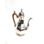 A SILVER COFFEE POT by Mappin & Webb, London 1909, of panelled baluster form on a rim foot, 21.5cm