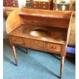 A WILLIAM IV MAHOGANY WASHSTAND the gallery with shelf, the top with circular recess for