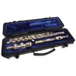 A SELMER FLUTE in a hard plastic travel case.